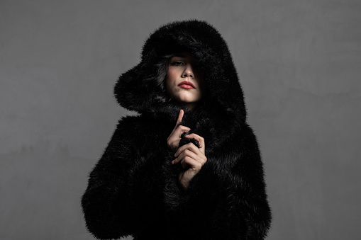 Beautiful woman wearing fur hood.