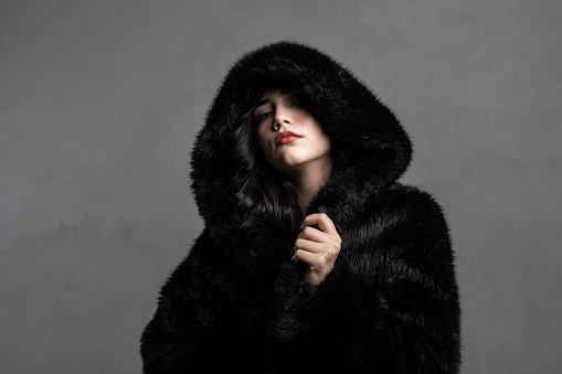 Beautiful woman wearing fur hood.