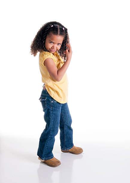 Smiling young girl posing. Full length studio shot isolated on white.