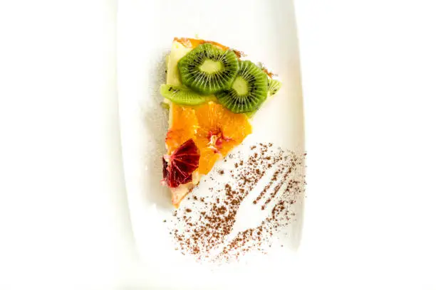 Fruitcake portion with kiwi and orange
