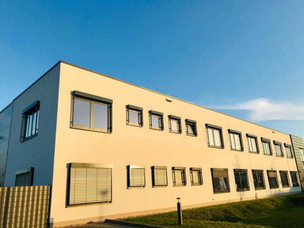 istock Yellowish concrete architectural building with sky background 1218938731