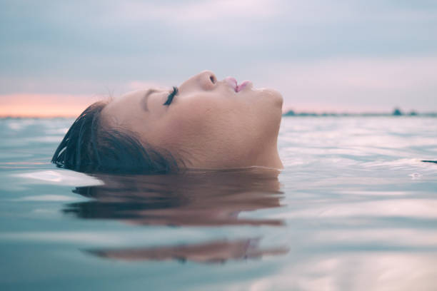 Asian model in the water enjoying a wellness spa.