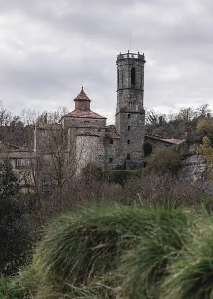 Medieval church in a spanish village near a green spot of grass