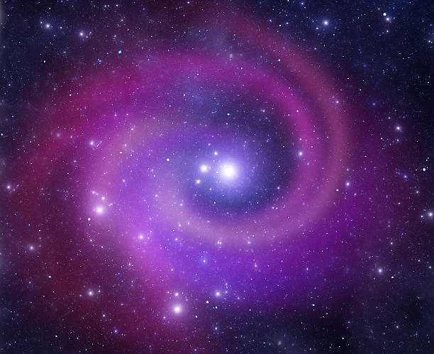 Purple and blue spiral galaxy swirling in space stock photo