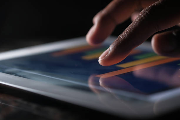 istock Close up of man hand analyzing chart on digital tablet 1218947009