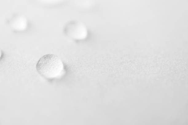 istock Water drops with selective focus on white background, macro. Concept moisturizing close-up. Aqua texture 1218947399
