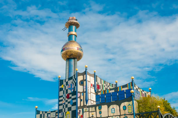 Tower of Garbage-processing plant in Vienna, Austria.  Designed by Friedensreich Hundertwasser. It was inaugurated in 1992 and heats 60000 apartments. Vienna, Austria - october 16, 2015: Tower of Garbage-processing plant in Vienna, Austria.  Designed by Friedensreich Hundertwasser. It was inaugurated in 1992 and heats 60000 apartments. hundertwasser house stock pictures, royalty-free photos & images