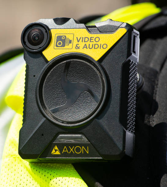 Body camera being worn by police officers in London, to keep officers safe, enabling situation awareness, improving community relations and providing evidence for trials. stock photo