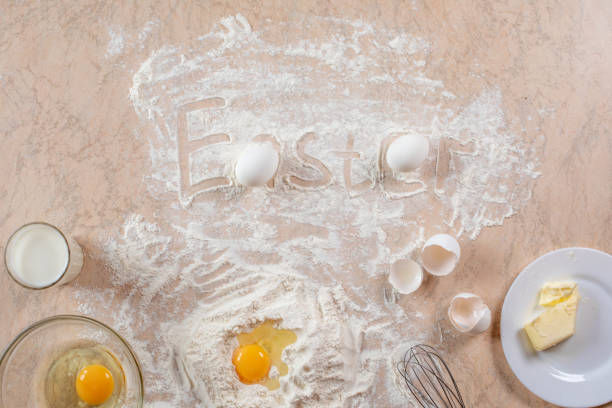 istock Kitchen table with ingredients for cooking baking. Copy space. Cooking concept. Eggs, flour on background. Dough ingredients. 1218950171