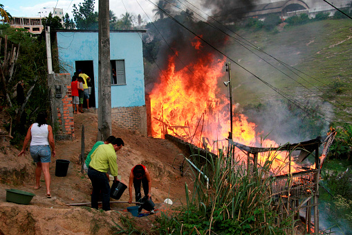 eunapolis, bahia / brazil - July 21, 2008: Population fights fire in residence in Eunapolis City Center.