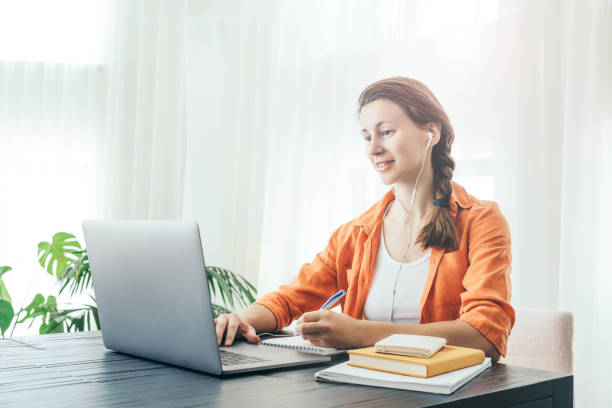 istock Woman sits in front of lap top. 1218952909