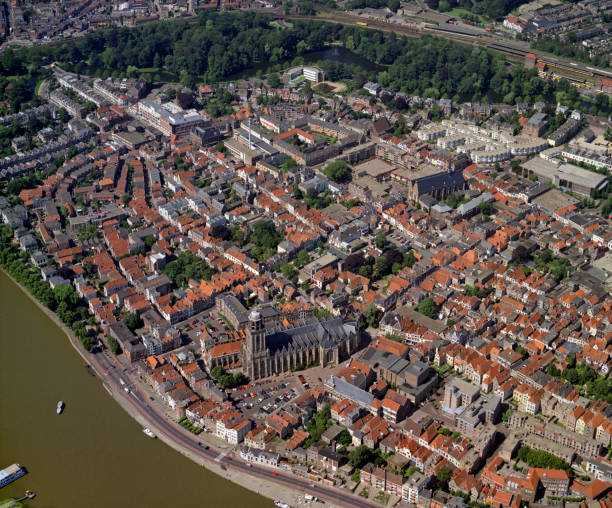 Deventer, Holland, July 11 - 1990: Historical aerial photo of the city Deventer situated on the east bank of the river IJssel Deventer, Holland, July 11 - 1990: Historical aerial photo of the city Deventer situated on the east bank of the river IJssel and Lebuinuskerk in front in the province Overijssel deventer photos stock pictures, royalty-free photos & images