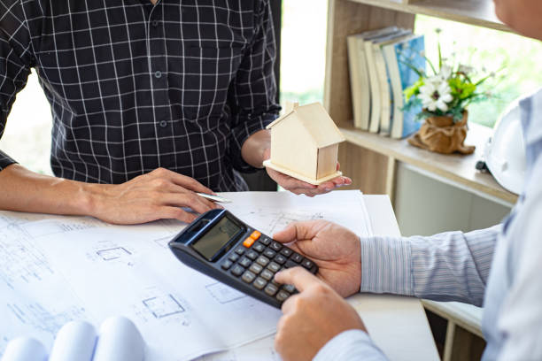 istock Engineers or architects are meeting a team to design the architectural structure in the design with blueprints and model buildings in working site, Technological structure and construction Concept. 1218955076