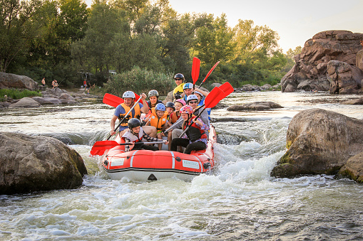 Sun Kosi near Harkapur / Nepal - August 30, 2019: Whitewater Rafting on the Dudh Koshi in Nepal. Rafting team , summer extreme water sport. Group of people whitewater rafting and rowing on river.