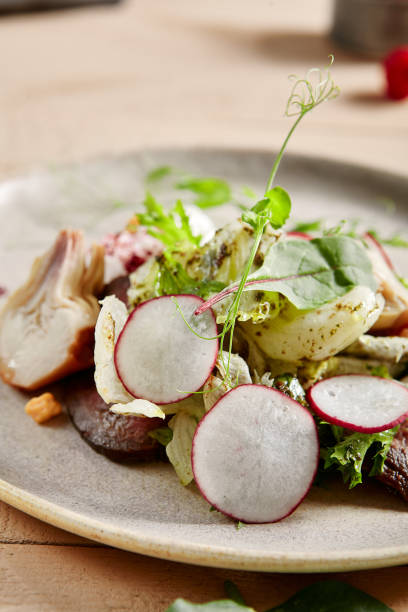 istock Roast beef, artichokes and poached egg salad in white plate closeup 1218959598