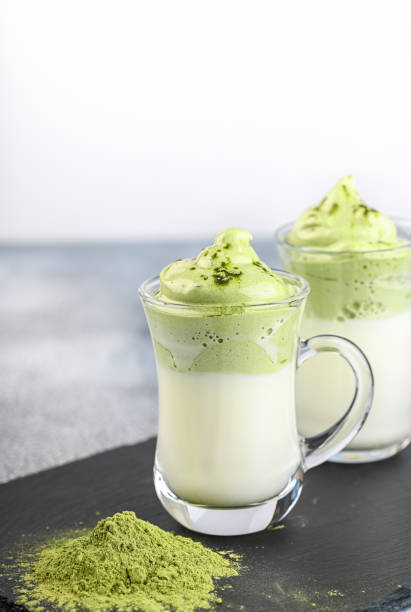 istock Two cups Dalgona Matcha Latte, a creamy whipped matcha, on light background. Matcha green tea. 1218959723
