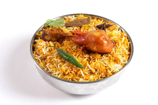 Delicious spicy chicken biryani in traditional bowl on White background, Indian or Pakistani famous masala rice food. Potato and meat are main ingredients of this recipe | Best Ramadan iftar meal.