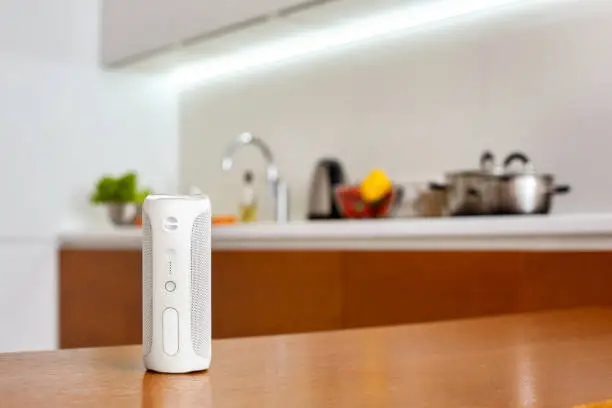 Photo of Innovation, Smart wireless speaker on table at home close-up blurred background