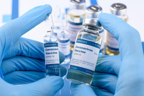 istock Coronavirus COVID-19 vaccine vials in scientist hands concept 1218961394