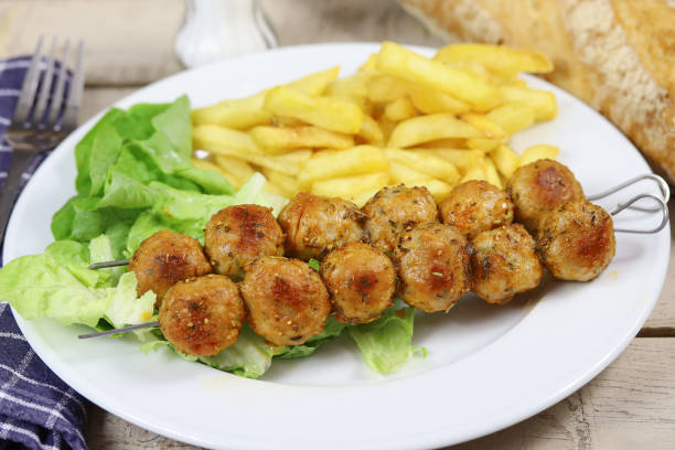istock chicken skewers and fries on a plate 1218963870