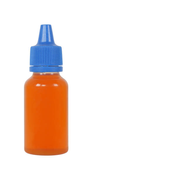 istock Little bottle with blue lid and dark liquid inside 1218964311