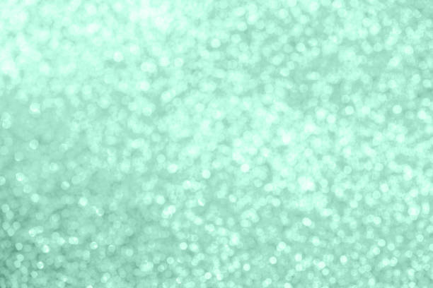 istock Christmas festive abstract background toned in neon mint color, soft focus. 1218965411