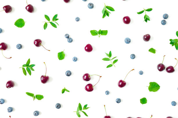 istock Cherry and blueberries with mint leaves on white background. Top view. Flat lay 1218965523