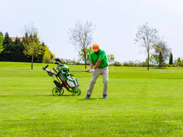 istock Close up Golfer is driving golf ball to green course 1218967115