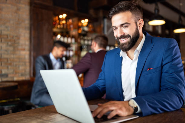 istock Handsome business man using laptop at his work break in restaurant 1218969205
