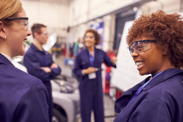 istock Female Tutor By Whiteboard With Students Teaching Auto Mechanic Apprenticeship At College 1218969336