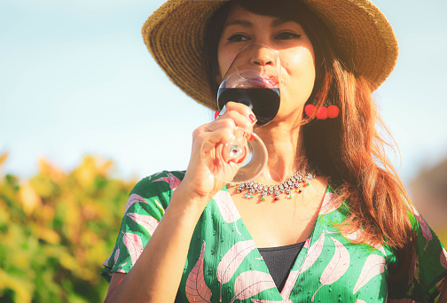 Happy asian woman drinking red wine glass,  celebration concept