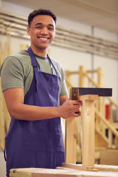 istock Portrait Of Male Student Studying For Carpentry Apprenticeship At College Using Set Square 1218970024