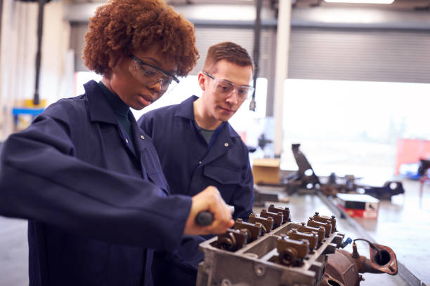 istock Male And Female Students Work On Car Engine Block On Auto Mechanic Apprenticeship Course At College 1218970244