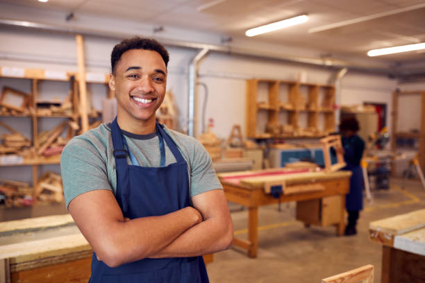 Portrait Of Male Student Studying For Carpentry Apprenticeship At College Portrait Of Male Student Studying For Carpentry Apprenticeship At College woodshop stock pictures, royalty-free photos & images