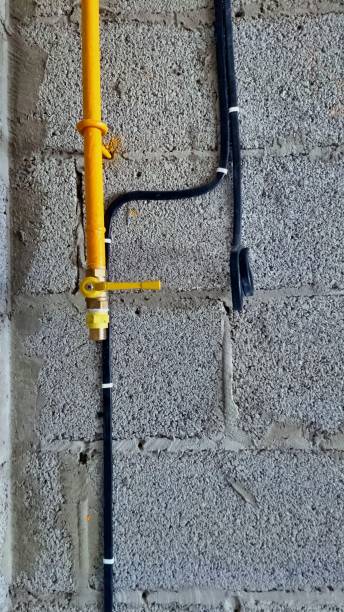 istock gas pipe and flat cable fixed to the cinder block wall 1218970909