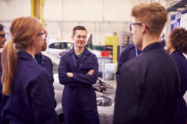 istock Group Of Students Studying For Auto Mechanic Apprenticeship At College 1218971962