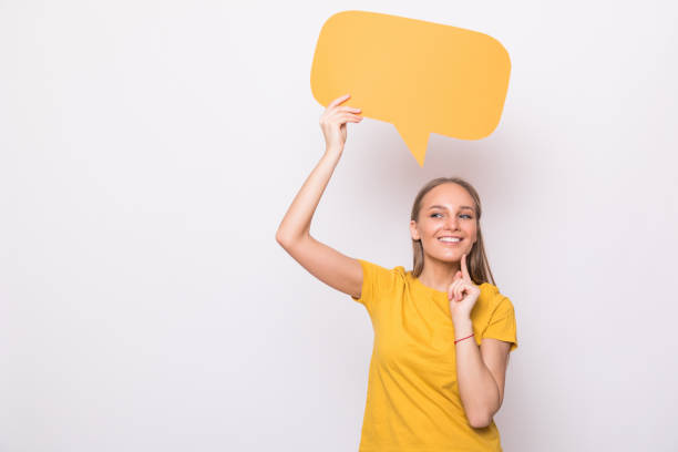 istock Young beautiful girl holding a orange bubble for text, isolated on a white background 1218973973