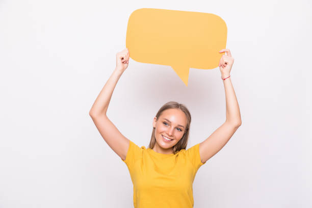 istock Young beautiful girl holding a orange bubble for text, isolated on a white background 1218974014