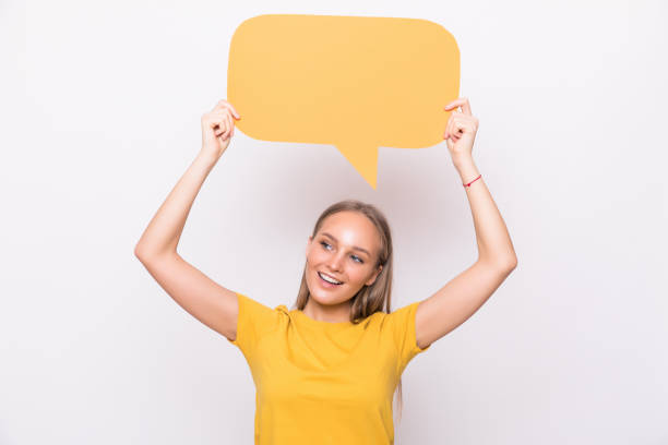 istock Young beautiful girl holding a orange bubble for text, isolated on a white background 1218974034