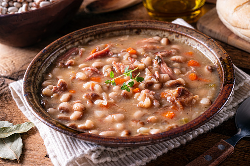 A bowl of delicious homemade bean soup with smoked ham.