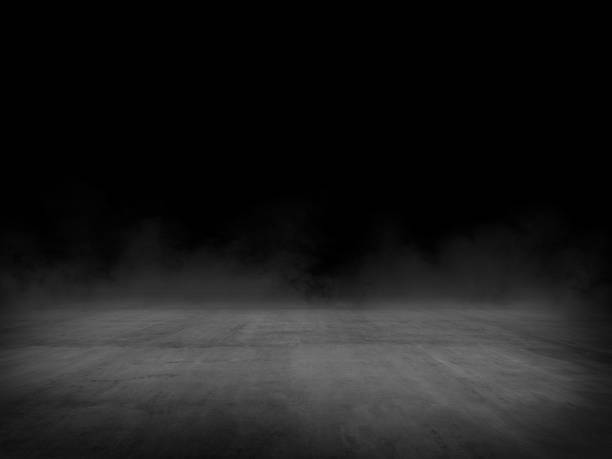istock Empty spot lit concrete floor with fog, dark background 1218975134