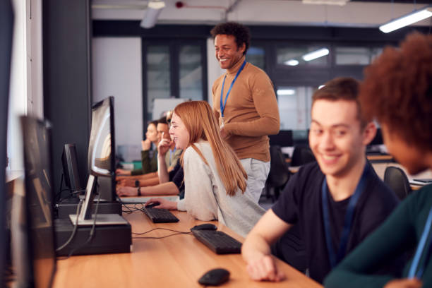 istock Group Of College Students With Tutor Studying Computer Design Sitting At Monitors In Classroom 1218975654