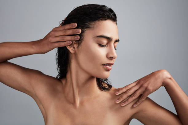 A full-body scrub is just what you need Studio shot of a beautiful young woman posing against a grey background wet hair stock pictures, royalty-free photos & images