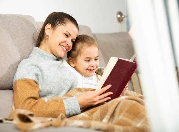 istock Mother reads an interesting book for her small daughter 1218976120
