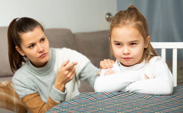 istock Frustrated small girl sitting at sofa,  having conflict with mother 1218976128