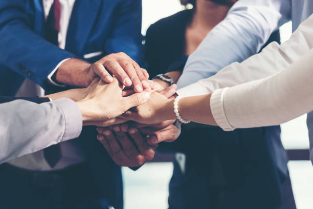 istock Partners Team work joining hands to success together. Business Team stack of hands for star up project. Team work Concept 1218976290