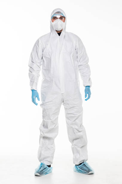 istock Young man in chemical protective suit making stop gesture on white background. Virus research 1218979177