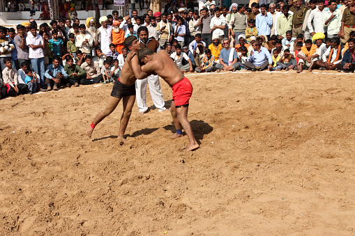 Pushakar, India - November 19,2010:Unidentified men engaged in traditional wrestling in Pushkar Camel Fair in Pushkar, Rajastan, India.