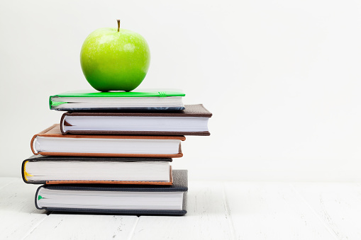 Office desk workspace table with supplies and apple. With copy space for your text