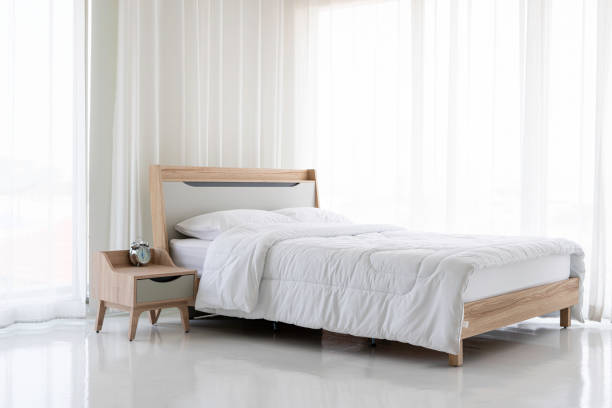 istock Wooden bed, white mattress, white curtain 1218981040